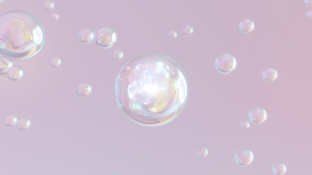 fotografía macro de varias burbujas de color en el agua que se elevan sobre un fondo claro