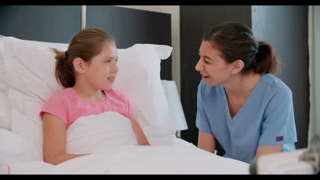 Child-Patient-In-Bed-Talking-To-Doctor-In-Hospital-Room