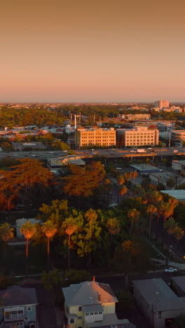 lively traffic by the road in sacramento, california, united states. beige color sky at backdrop. aerial view. vertical video