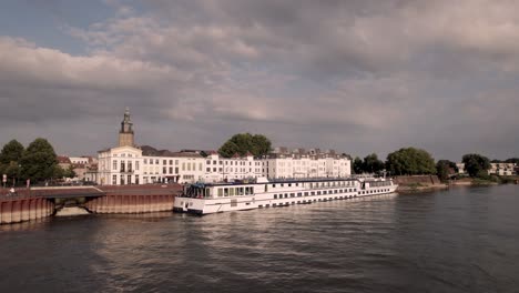 aerial approach of large tourist river cruise passenger boat dutch melody on a sunny day seen from the river ijssel with city countenance behind