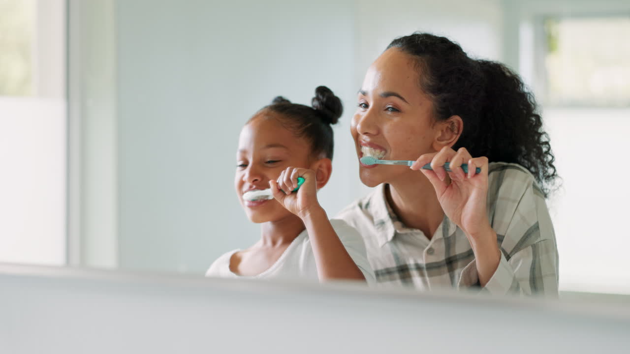 Toothbrush, mother and daughter in mirror