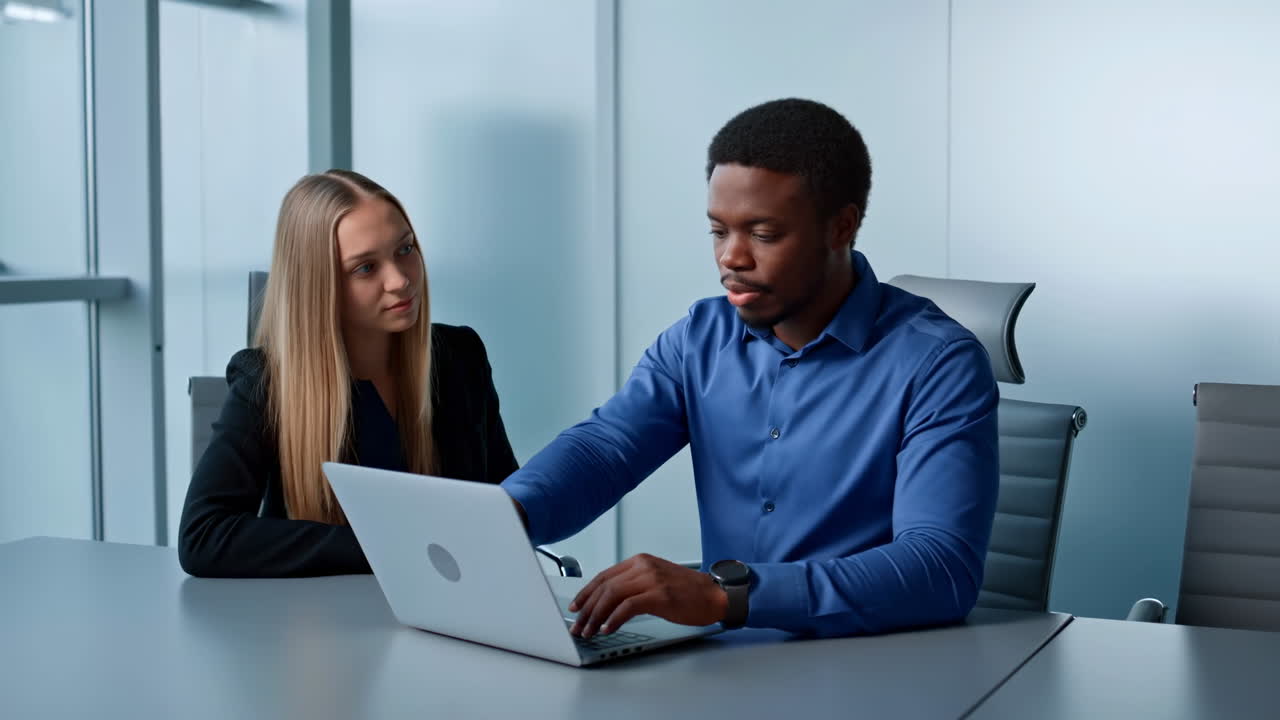 Diverse Business Colleagues Working Together on Laptop in Office