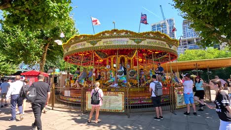 people enjoying a carousel ride in london