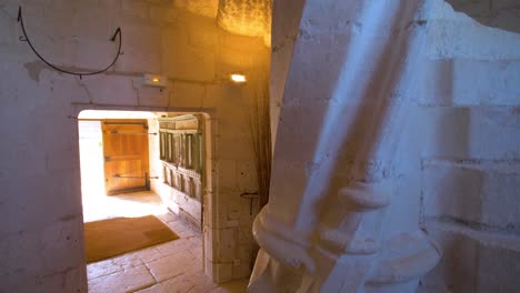 ornate interiors of historic french chateau with ambiently lit hallway