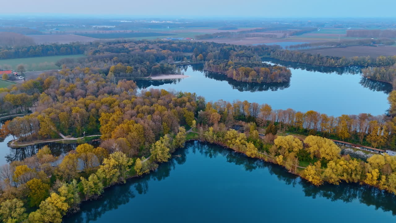 Aerial view of Dutch lakes. Stunning aerial landscape showcasing tranquil lakes surrounded by vibrant autumn foliage in the Netherlands