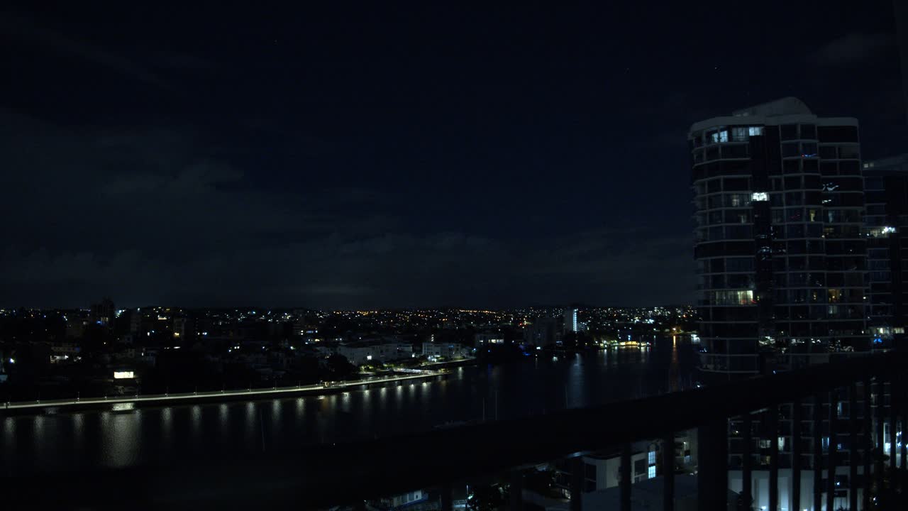 Night View of City Skyline with River and Highrise Building