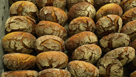 sourdough bread buns being sold in a bakery shop - overhead slider shot