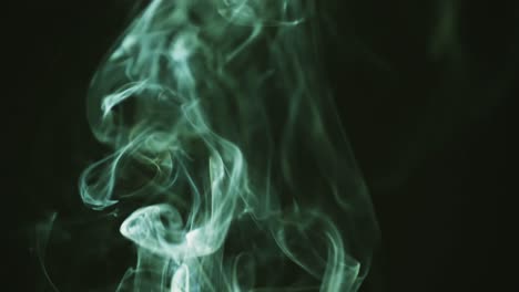 Video-of-green-clouds-of-smoke-moving-with-copy-space-on-black-background