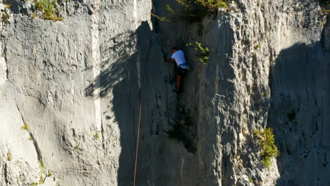 skilled and strong rock climber climbing on limestone canyon of vela draga in croatia