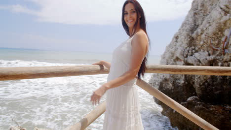 Lady-Holding-at-Beach-Railing-with-Air-Blown-Hair