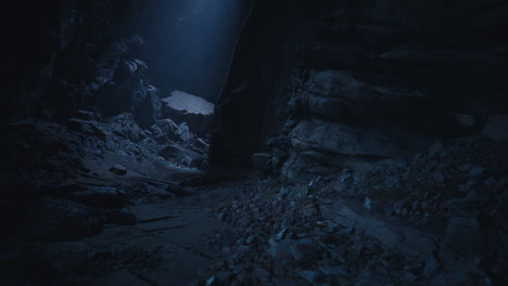 dark cave exploration revealing rocky terrain and distant light