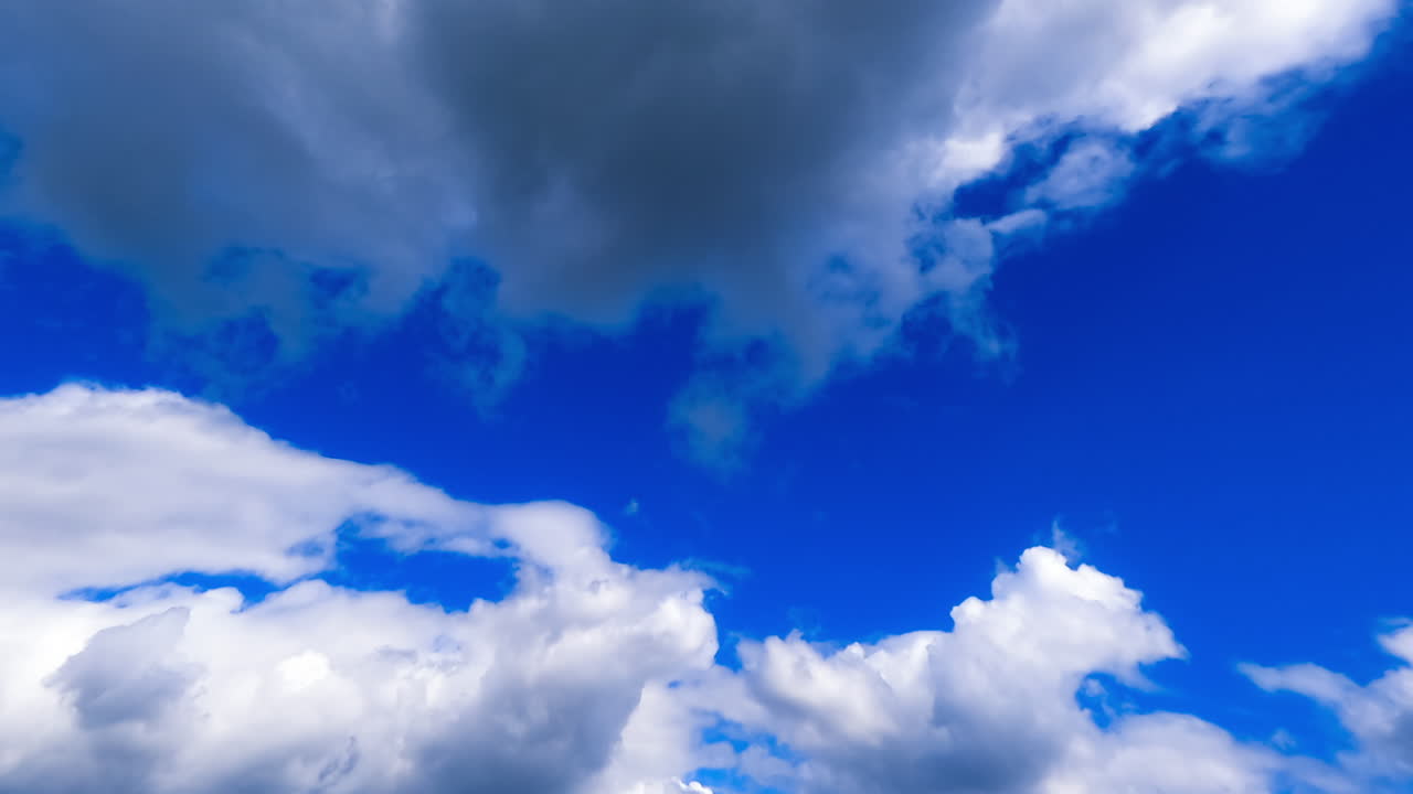 Timelapse of fluffy clouds motion. Blue sky with clouds flowing over.