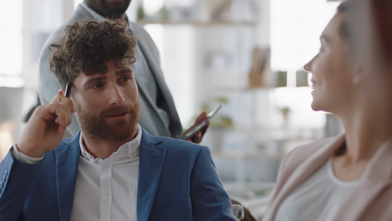 joven hombre de negocios atractivo charlando con colegas en la oficina reunión teniendo conversación compartiendo ideas en el lugar de trabajo corporativo