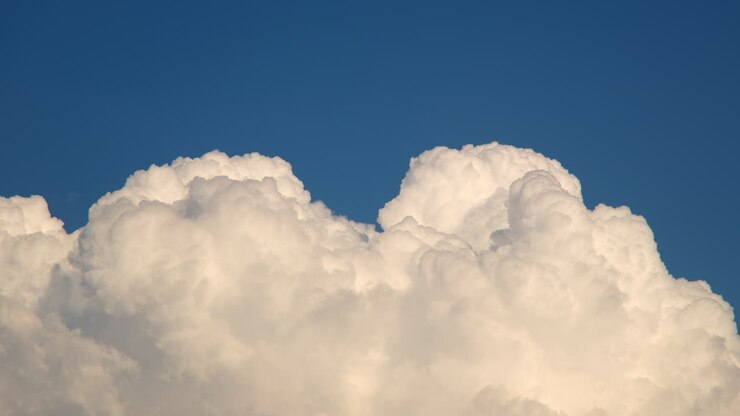 Clouds time lapse against blue sky and sun rays