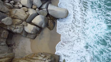 Rocky-Shoreline-at-Tayrona-Beach-in-Santa-Marta,-Colombia-in-aerial-top-down-view