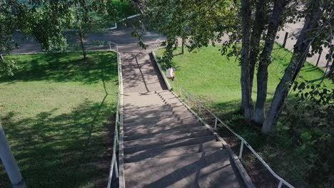 skater performing a trick on outdoor stairs in a park