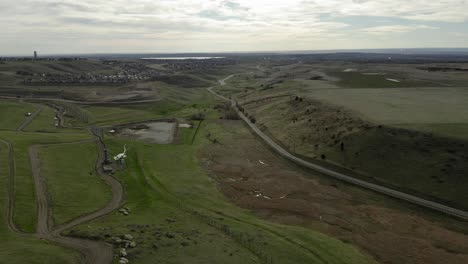 Aerial-pull-back-over-rock-formation-and-field