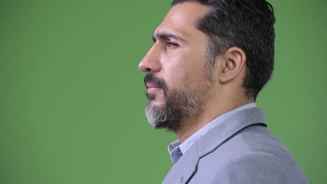 profile view of handsome persian bearded businessman smiling
