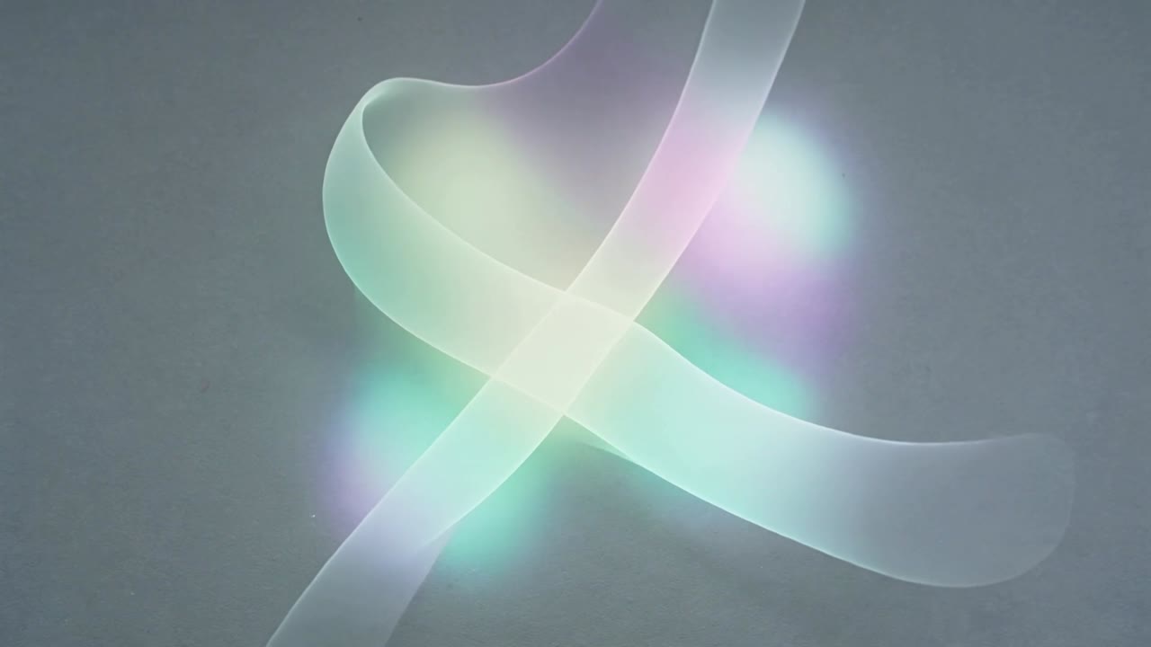 Shifting two thin ribbons crossing and twisting on gray wall as frames advance, glowing pastel orbs