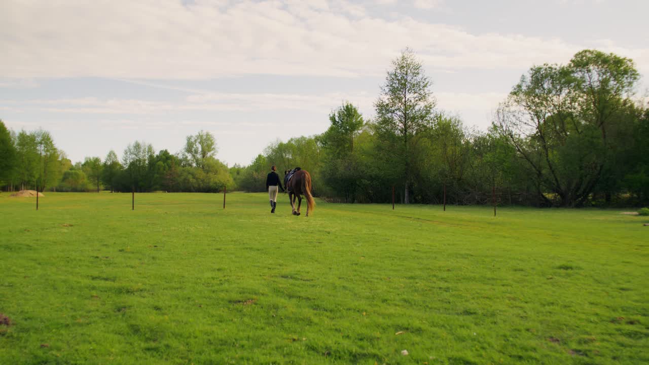 Woman and Horse Walking Through a Field