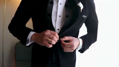 a man wearing the suit for his wadding - close up - fixed camera