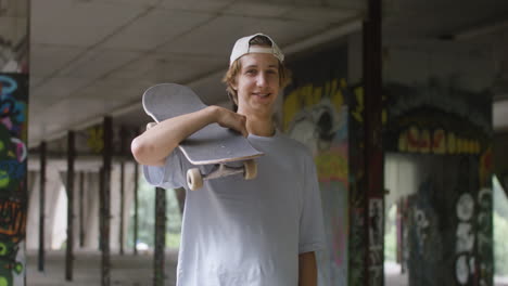 caucasian skateboarder in a ruined building.