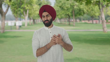 sick sikh indian man having an heart attack in park