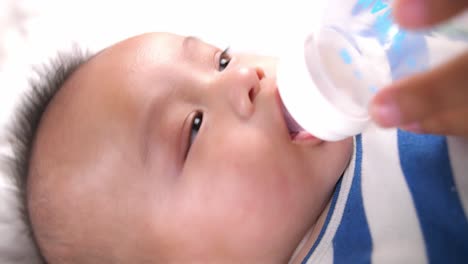 baby drinking water from bottle, video in 4k