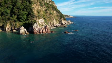 Kayaking-Around-Cape-with-Rocky-Shore-of-Panoramic-Coastline-in-Clear-Blue-Waters-of-the-Ionian-Sea-in-Albania