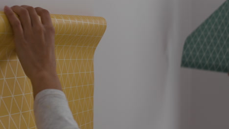 couple decorating their home with wallpaper