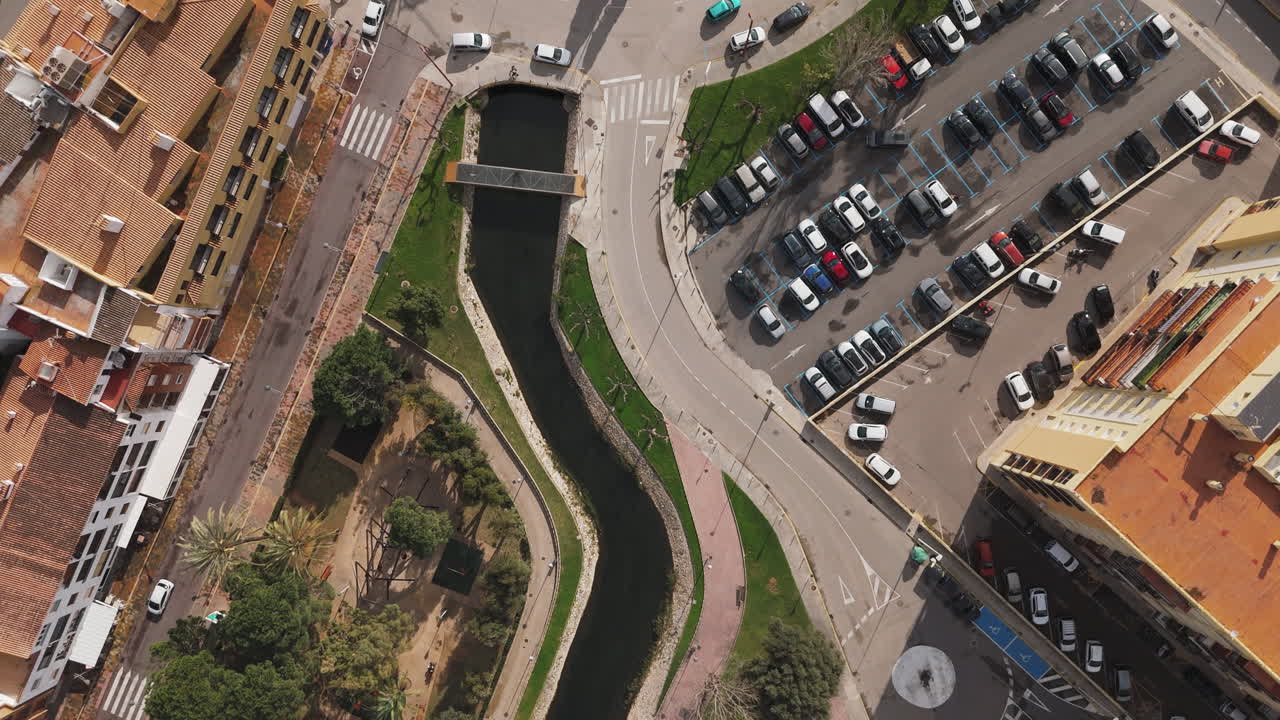 Close aerial of Plaça Constituciò in Peniscola with green space and curved paths