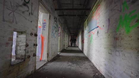 two dark figures making their way along shadowy corridor, slow motion