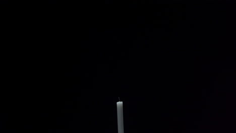 a candle is being lit with a matchstick