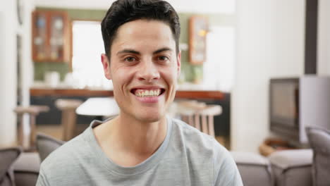 Portrait-of-thoughtful,-happy-biracial-man-smiling-at-home,-slow-motion