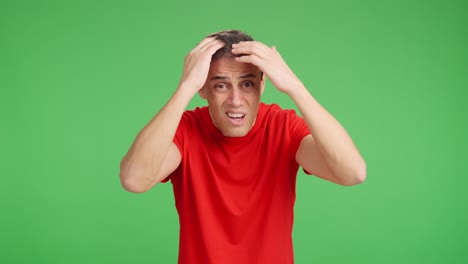 man expressing worry about hair loss on green screen