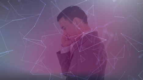 animation of network of connections over businessman talking on smartphone in background