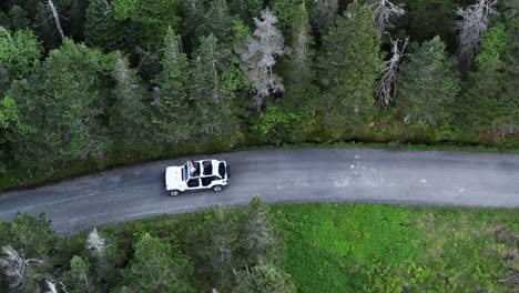 aerial drone headshot of jeep in stowe forest road, vermont