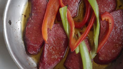 turkish sausage with peppers in a pan