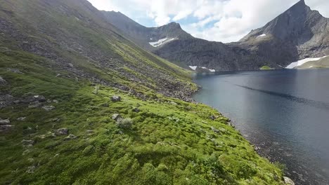 fpv drone gracefully glides amidst mountain lakes, weaving towards towering peaks, offering a breathtaking aerial tour of alpine beauty