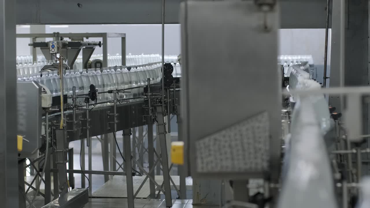 Conveyor belt with bottles of drinking water at a modern beverage plant