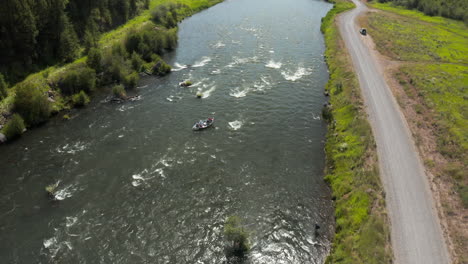 fly over drone footage of driftboat along henry's fork snake river in southeastern idaho, usa