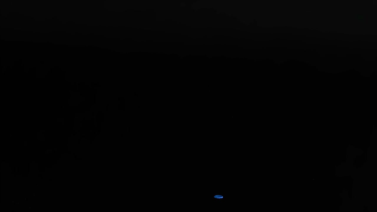 Colorful balls and a rubber duck bounce dynamically against a dark background, showcasing playful motion.