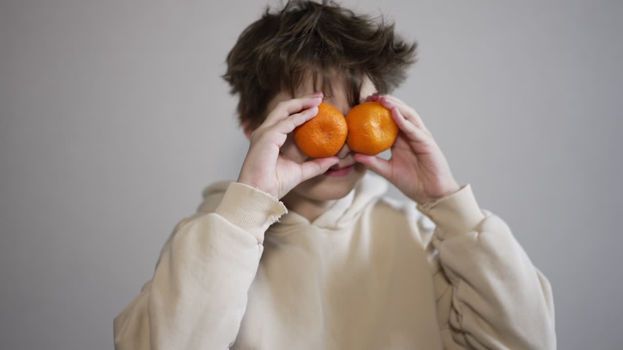 Boy with Oranges on Face