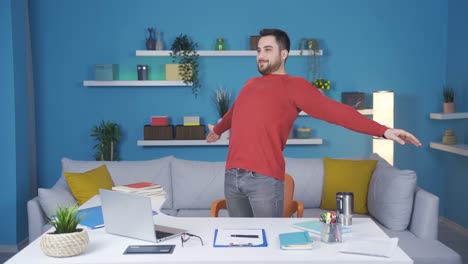 young businessman showing how to do relaxing exercise in home office. she does standing back and arm exercises.