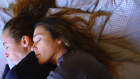 lesbian couple sleeping together in bedroom 4k