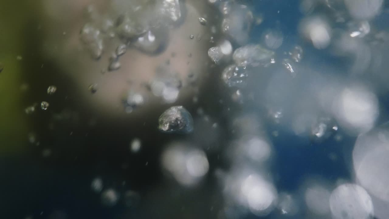 person underwater blowing Blurred underwater bubbles with soft light, creating a dreamy abstract effect