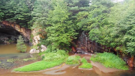 4k drone video of cave and waterfall at emerald village near little switzerland, nc on summer day-6
