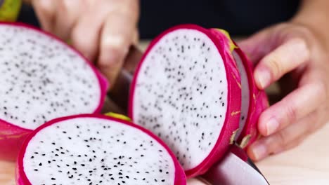 hands slicing dragon fruit with a knife