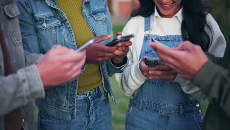 a group of friends using smartphones outdoors