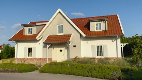 Beautiful-white-big-house-in-gated-residential-area-during-spring-on-a-sunny-day